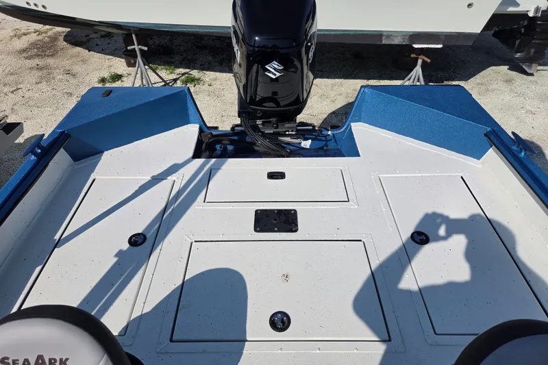 Slide: The Image of 2026 SeaArk Big Easy boat deck with motor, featuring blue and white design. - 2