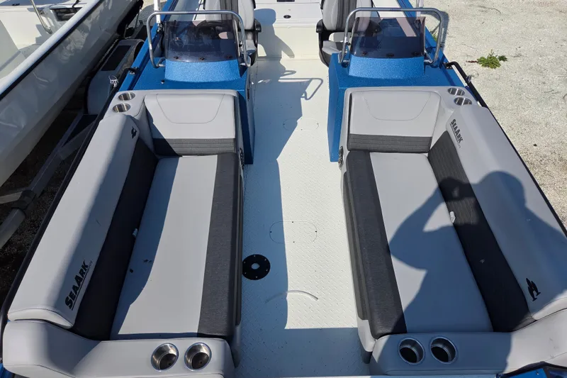 Slide: The Image of 2026 SeaArk Big Easy boat interior with dual seating and cup holders. - 13