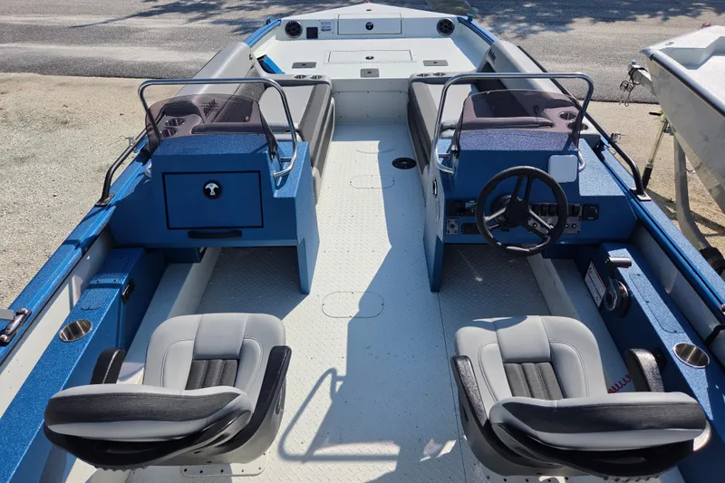 Slide: The Image of 2026 SeaArk Big Easy boat interior with dual seating and steering console. - 5