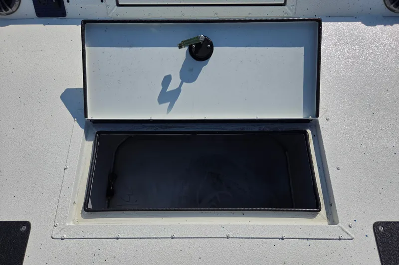 Slide: The Image of Open storage compartment on 2026 SeaArk Big Easy boat deck. - 11