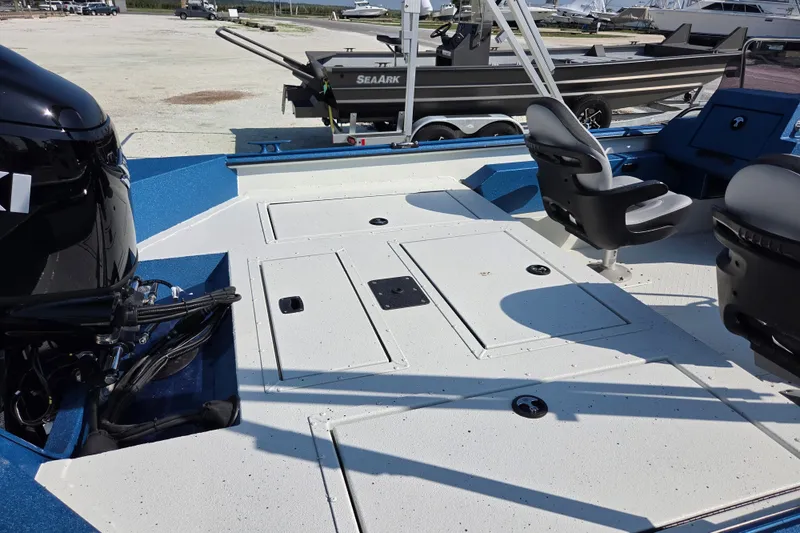 Slide: The Image of 2026 SeaArk Big Easy boat interior with seating and storage compartments. - 7