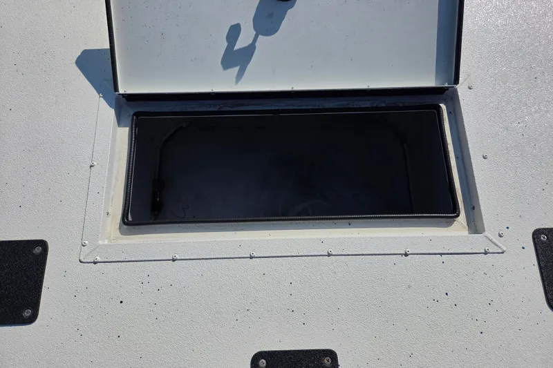 Slide: The Image of Open storage compartment on 2026 SeaArk Big Easy boat deck. - 10