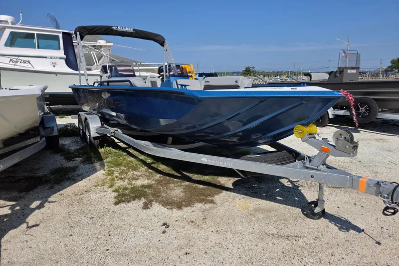 The Image of 2026 SeaArk Big Easy boat on trailer, parked outdoors under clear blue sky. - 0