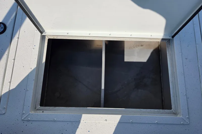 Slide: The Image of Open storage compartment on a 2026 SeaArk Big Easy boat. - 1