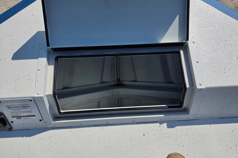 Slide: The Image of Open hatch on 2026 SeaArk Big Easy boat, showcasing interior storage compartment. - 12