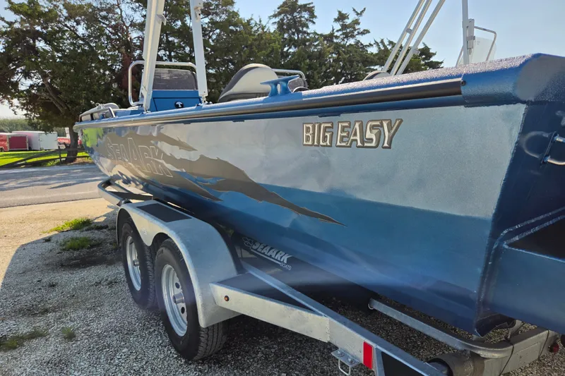 Slide: The Image of 2026 SeaArk Big Easy boat on trailer, parked outdoors. - 8