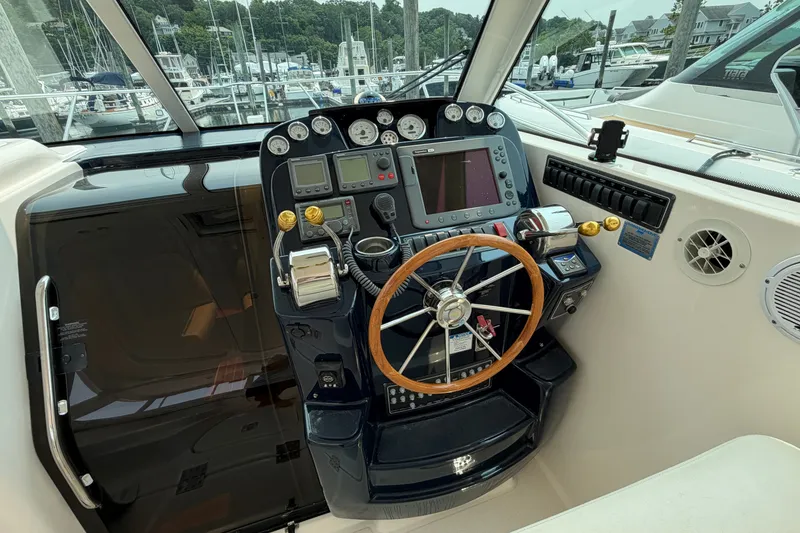 Slide: The Image of 2008 Tiara Yachts 3000 Open helm with navigation instruments and wooden steering wheel. - 8
