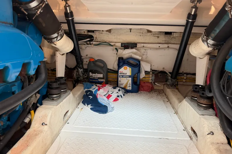 Slide: The Image of Engine compartment of a 2008 Tiara Yachts 3000 Open with oil containers and tools. - 18
