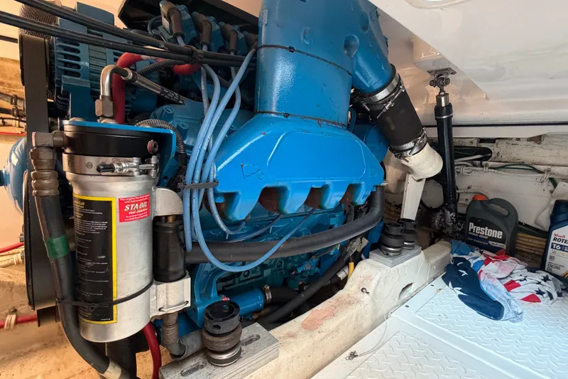 Slide: The Image of Engine compartment of a 2008 Tiara Yachts 3000 Open, featuring a blue engine and maintenance supplies. - 19