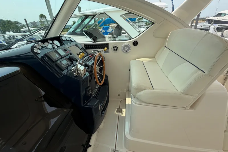 Slide: The Image of 2008 Tiara Yachts 3000 Open helm with steering wheel and navigation instruments. - 9