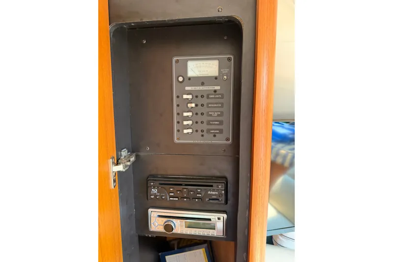 Slide: The Image of Electrical control panel inside 2008 Tiara Yachts 3000 Open, featuring switches and audio system. - 14