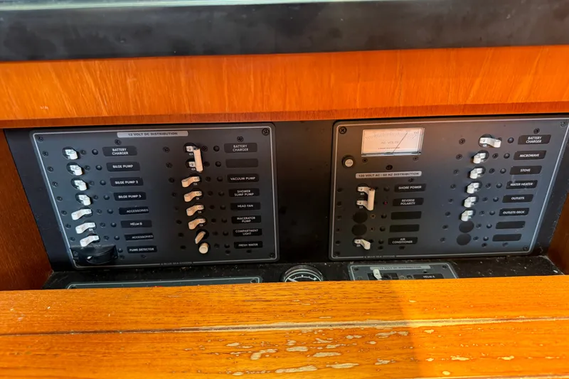 Slide: The Image of Control panel of a 2008 Tiara Yachts 3000 Open, featuring various switches and gauges. - 12