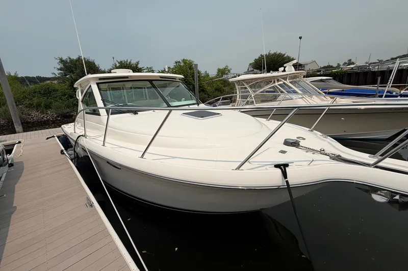 Slide: The Image of 2008 Tiara Yachts 3000 Open docked, showcasing sleek design and spacious deck. - 1