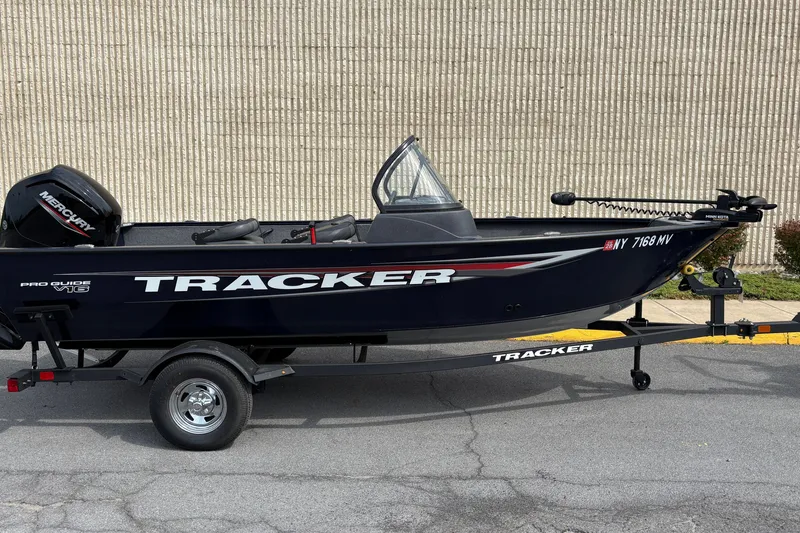 The Image of 2025 Tracker Pro Guide V-16 WT boat on trailer, parked outdoors. - 0