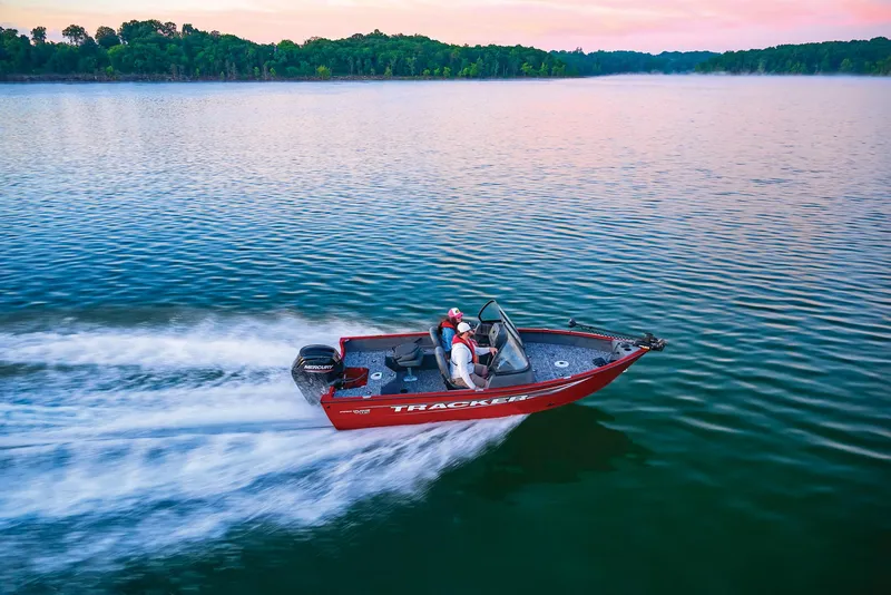 Slide: The Image of Manufacturer Provided Image: 2025 Tracker Pro Guide V-16 WT boat speeding on a serene lake at sunset. - 49