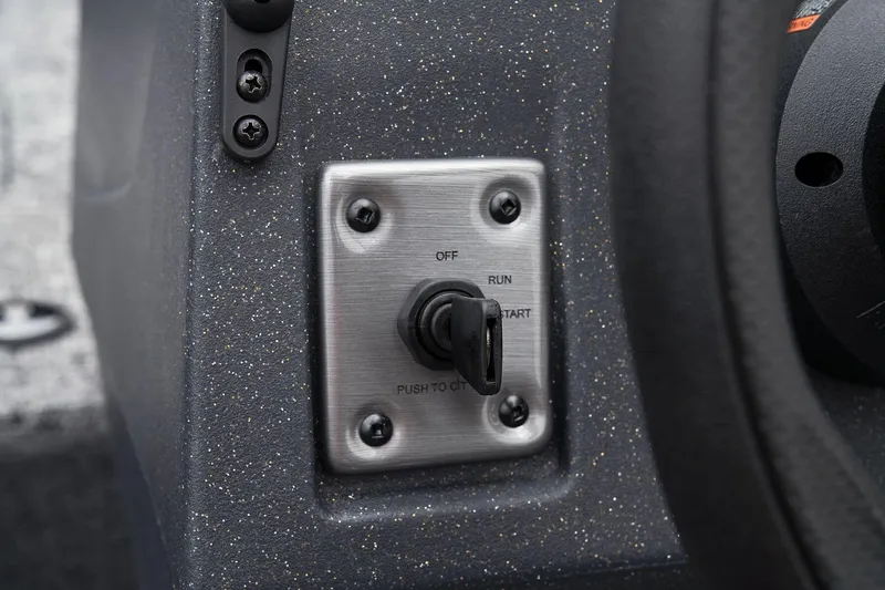 Slide: The Image of Manufacturer Provided Image: 2025 Tracker Pro Guide V-16 WT ignition switch on a textured dashboard. - 33