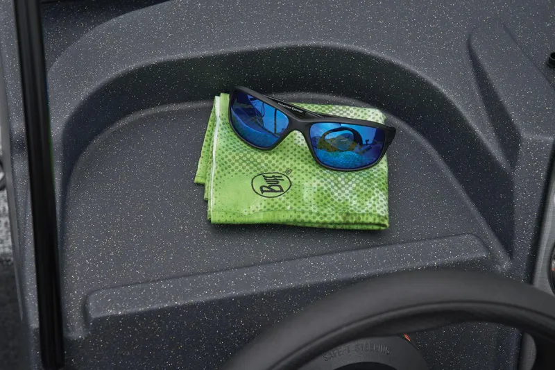 Slide: The Image of Manufacturer Provided Image: Sunglasses on green cloth in 2025 Tracker Pro Guide V-16 WT boat interior. - 34