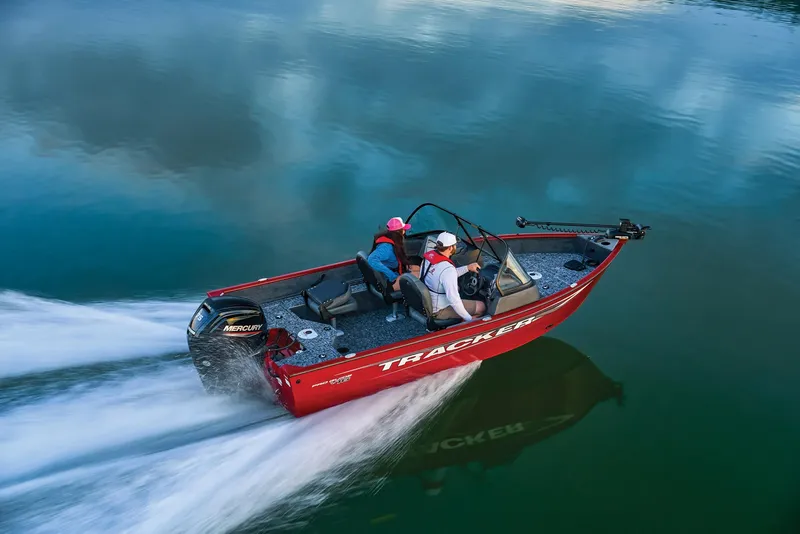 Slide: The Image of Manufacturer Provided Image: 2025 Tracker Pro Guide V-16 WT boat speeding on calm water, showcasing sleek design and performance. - 50