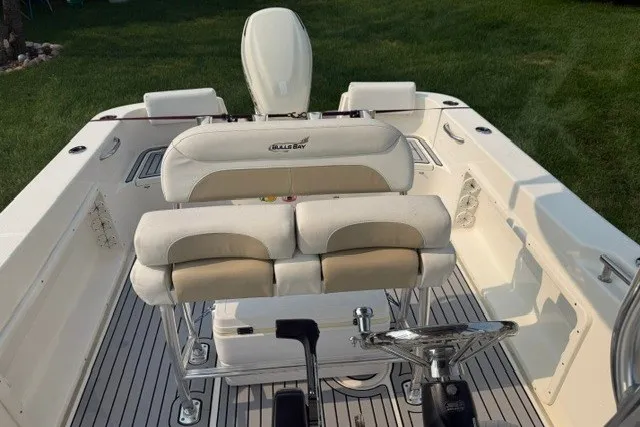 Slide: The Image of 2021 Bulls Bay 230 Center Console boat interior with seating and steering wheel. - 17