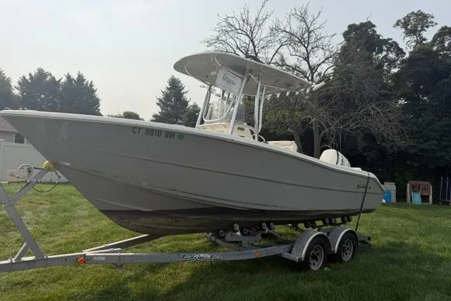 The Image of 2021 Bulls Bay 230 Center Console boat on trailer, parked on grass. - 0