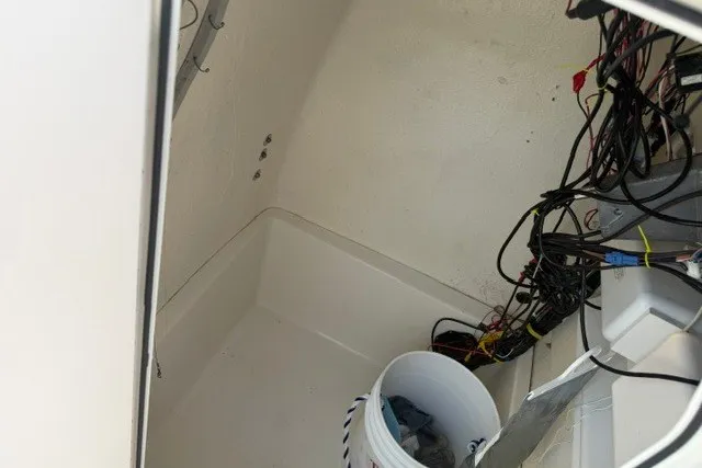Slide: The Image of Interior view of a 2021 Bulls Bay 230 Center Console boat with wiring and a bucket. - 23