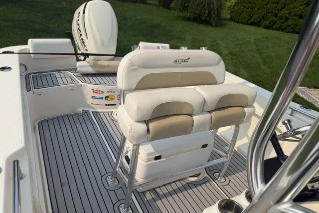 Slide: The Image of 2021 Bulls Bay 230 Center Console boat interior with cushioned seating and sleek deck design. - 18