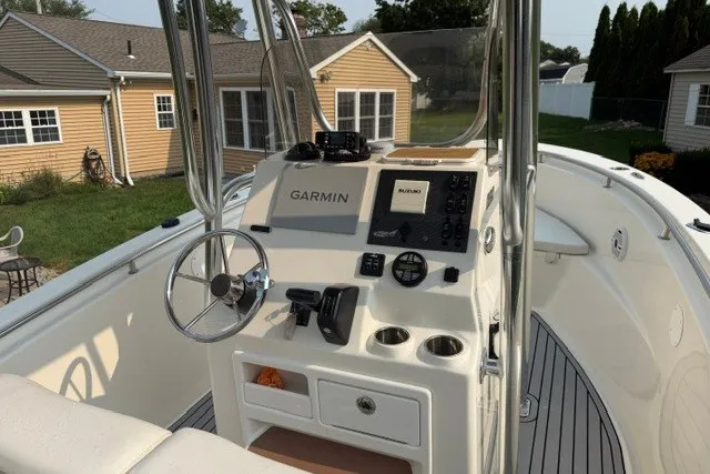 Slide: The Image of 2021 Bulls Bay 230 Center Console boat with Garmin navigation system and steering wheel. - 27