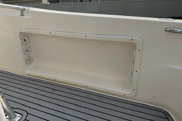 Slide: The Image of 2021 Bulls Bay 230 Center Console boat interior with storage compartment and deck view. - 13