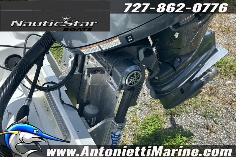 Slide: The Image of 2024 NauticStar 214 Bay boat engine close-up with contact details and logo. - 18