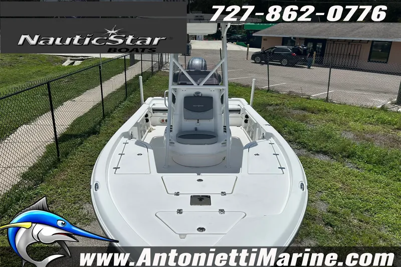 Slide: The Image of 2024 NauticStar 214 Bay boat displayed at Antonietti Marine dealership. - 6
