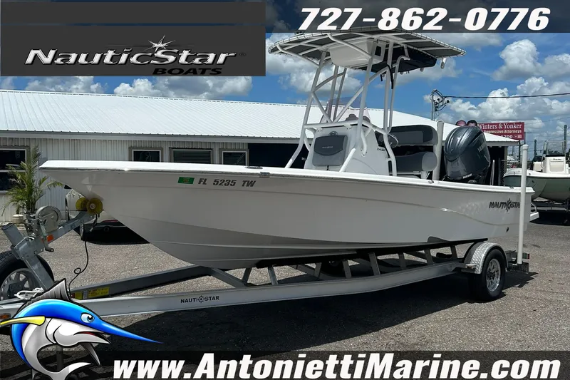 Slide: The Image of 2024 NauticStar 214 Bay boat on trailer at Antonietti Marine dealership. - 2