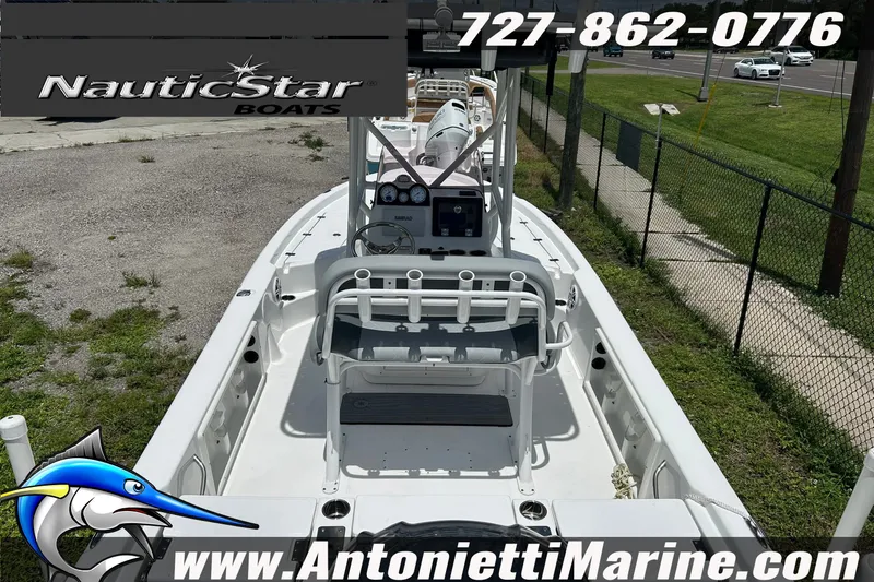 Slide: The Image of 2024 NauticStar 214 Bay boat displayed at Antonietti Marine dealership. - 8