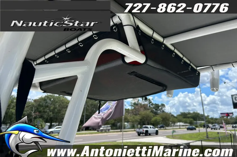 Slide: The Image of 2024 NauticStar 214 Bay boat canopy with logo and contact details, Antonietti Marine. - 17