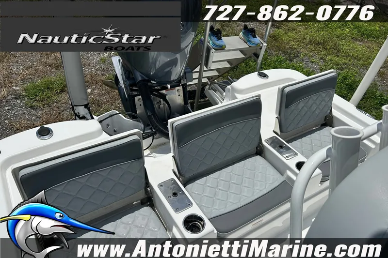 Slide: The Image of 2024 NauticStar 214 Bay boat interior with seating and logo, contact details visible. - 14