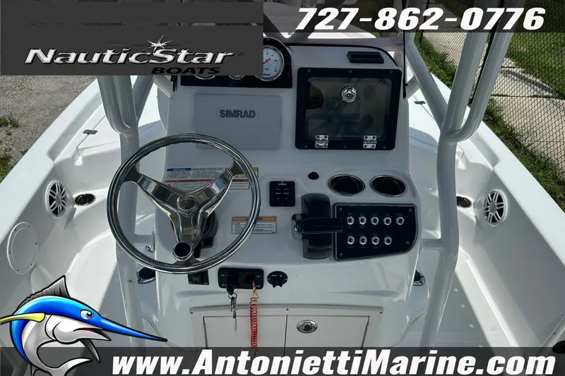 Slide: The Image of 2024 NauticStar 214 Bay boat dashboard with steering wheel and controls. - 15