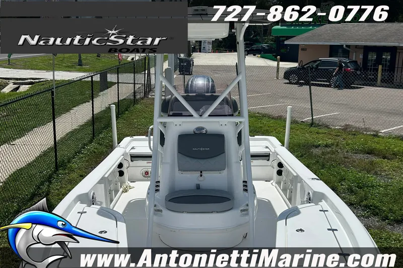 Slide: The Image of 2024 NauticStar 214 Bay boat displayed at Antonietti Marine dealership. - 7