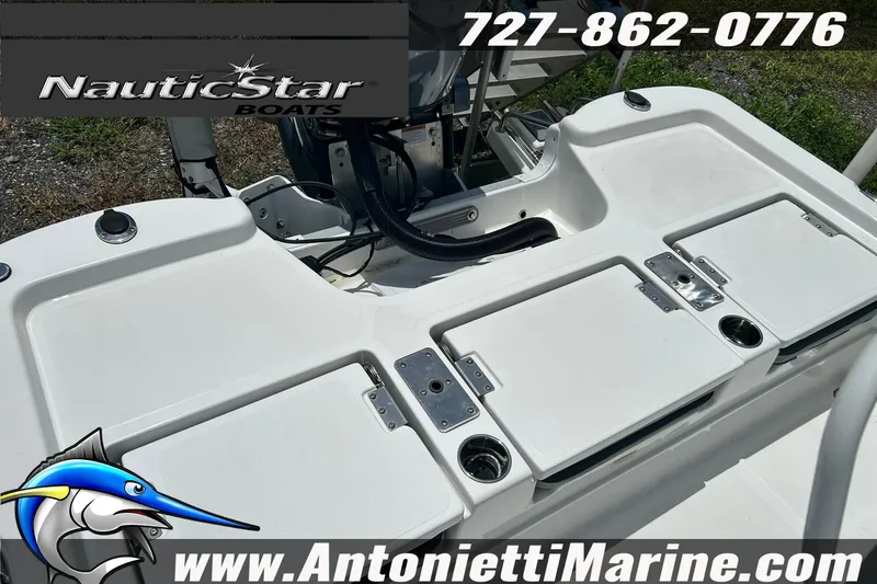 Slide: The Image of 2024 NauticStar 214 Bay boat deck with storage compartments and cup holders. - 13