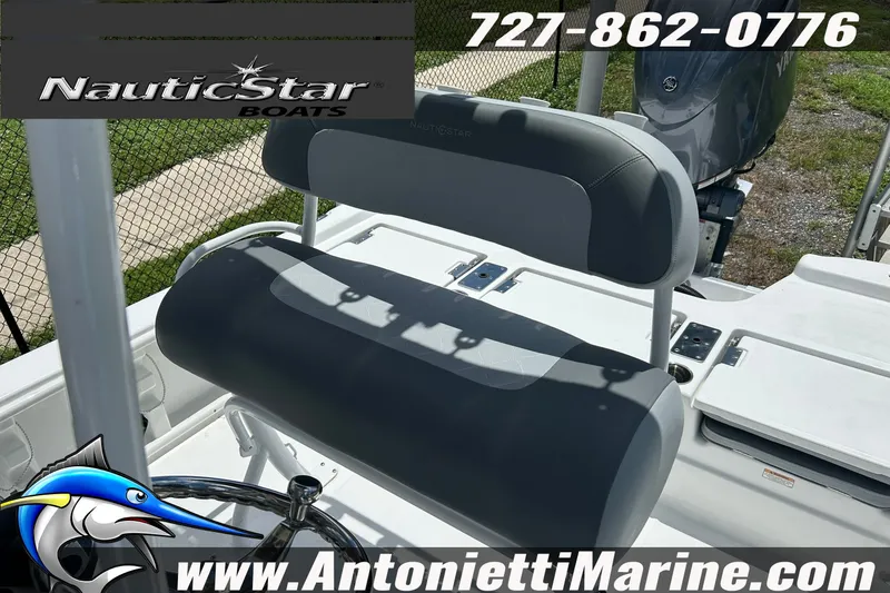 Slide: The Image of 2024 NauticStar 214 Bay boat interior with seating and steering wheel, showcased by Antonietti Marine. - 16