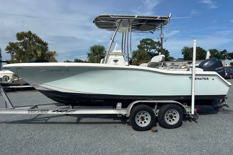 Slide: The Image of 2015 Tidewater 210 LXF boat on trailer, side view, outdoors, clear sky. - 2