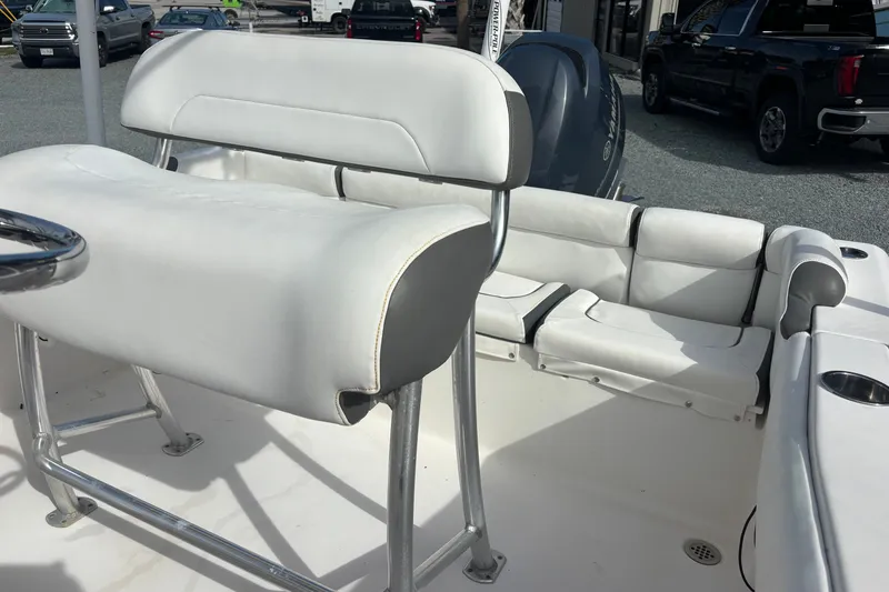 Slide: The Image of 2015 Tidewater 210 LXF boat interior with white seating and steering wheel. - 11