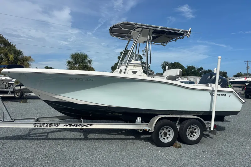 Slide: The Image of 2015 Tidewater 210 LXF boat on trailer under clear blue sky. - 1