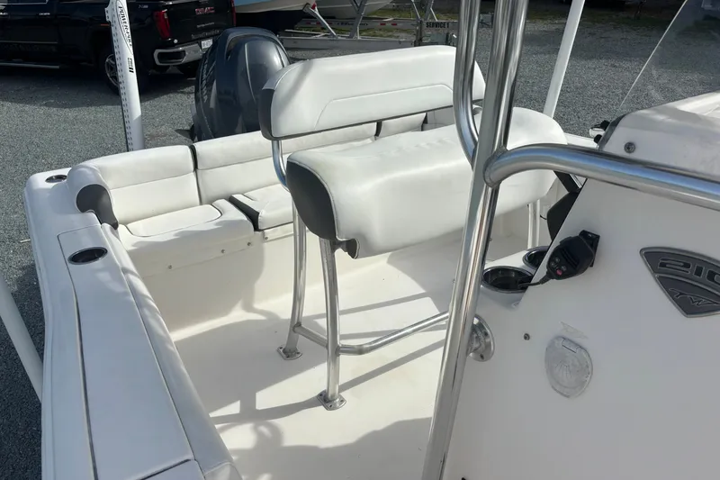 Slide: The Image of 2015 Tidewater 210 LXF boat interior with seating and console details. - 12