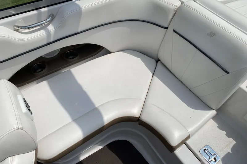 Slide: The Image of 2008 Four Winns H220 boat interior with white cushioned seating and cup holders. - 26