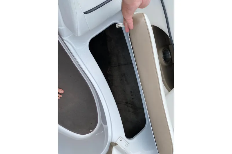 Slide: The Image of 2008 Four Winns H220 boat storage compartment with beige seating and white interior. - 73