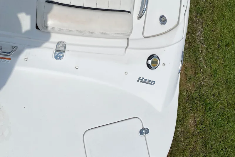 Slide: The Image of 2008 Four Winns H220 boat deck with white seating and storage compartments. - 24