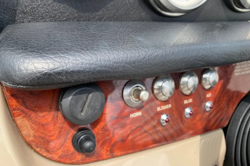 Slide: The Image of Dashboard controls of a 2008 Four Winns H220 boat, featuring horn and blower switches. - 54