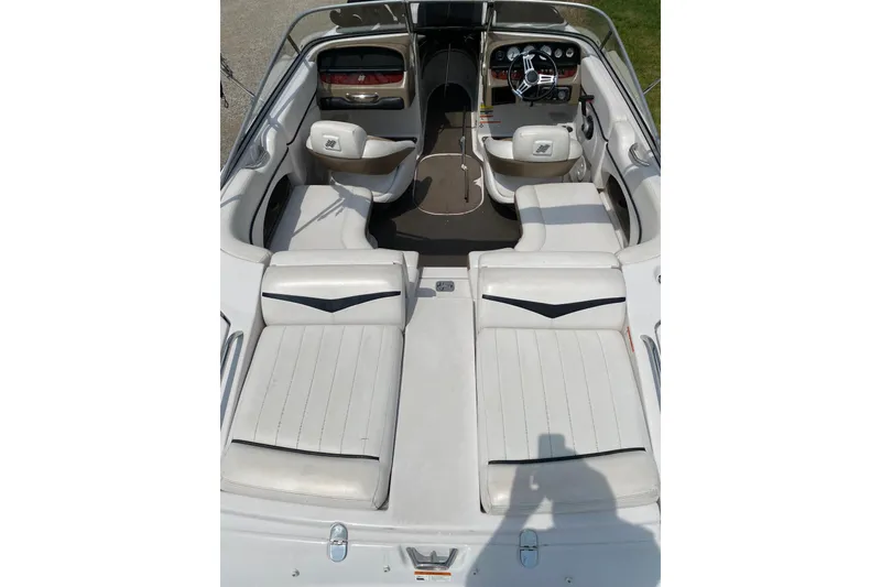 Slide: The Image of 2008 Four Winns H220 boat interior with white seating and steering console. - 28