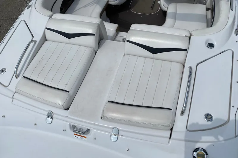 Slide: The Image of 2008 Four Winns H220 boat interior with white cushioned seating and sleek design. - 20