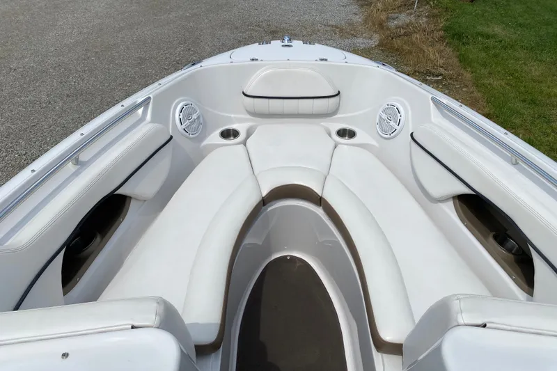 Slide: The Image of 2008 Four Winns H220 boat interior with white seating and cup holders. - 69