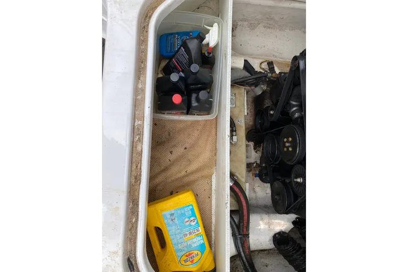 Slide: The Image of Storage compartment of a 2008 Four Winns H220 boat with engine maintenance supplies. - 41